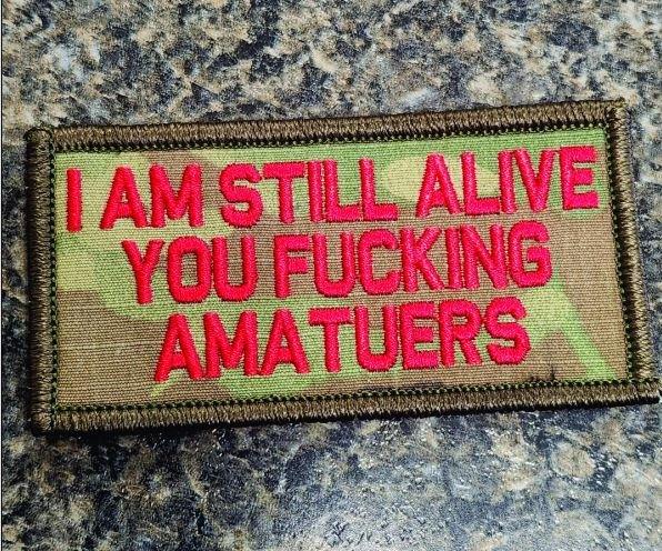 "I AM STILL ALIVE YOU FUCKING AMATEURS" TACTICAL MORALE PATCH - CAMO
