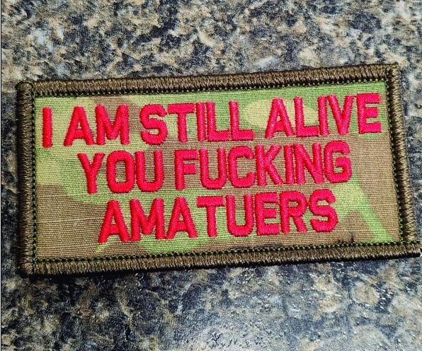 "I AM STILL ALIVE YOU FUCKING AMATEURS" TACTICAL MORALE PATCH - CAMO