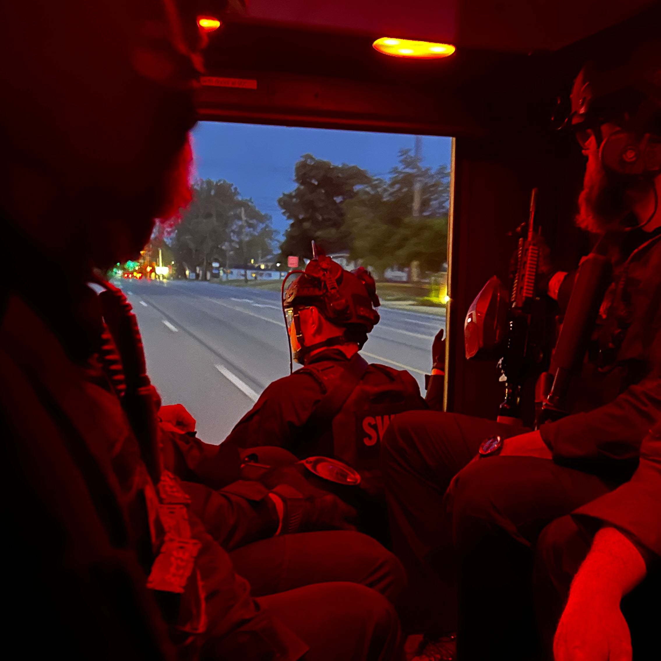 swat team in the back of an armored vehicle, red light